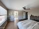Spacious main bedroom with ensuite bathroom, a large window with blinds, a ceiling fan, and a bench at 984 W Belmont Red Trl, San Tan Valley, AZ 85143