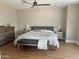 Serene main bedroom featuring a king bed, neutral tones, and hardwood floors for a cozy and relaxing atmosphere at 984 W Belmont Red Trl, San Tan Valley, AZ 85143