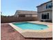 Backyard view of the in-ground pool with brick trim and desert landscaping at 984 W Belmont Red Trl, San Tan Valley, AZ 85143
