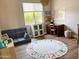 Playful ' room with hardwood floors, educational rug, and plenty of space for learning and creative activities at 984 W Belmont Red Trl, San Tan Valley, AZ 85143