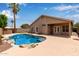 Backyard featuring a blue swimming pool, patio, and lush landscaping at 10280 N 94Th Dr, Peoria, AZ 85345