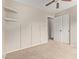 Bright bedroom with board and batten accent wall, ceiling fan, and carpeted flooring at 10280 N 94Th Dr, Peoria, AZ 85345