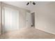 Bedroom with carpet, neutral walls, a closet and a door to another room at 10280 N 94Th Dr, Peoria, AZ 85345