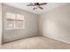 Cozy bedroom featuring a ceiling fan, neutral paint, and natural light from the window at 10280 N 94Th Dr, Peoria, AZ 85345
