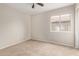 Comfortable bedroom featuring a ceiling fan, neutral paint, and natural light at 10280 N 94Th Dr, Peoria, AZ 85345