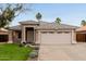 Charming single-story home with a well-manicured lawn, desert landscaping, and a two-car garage at 10280 N 94Th Dr, Peoria, AZ 85345
