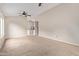 Bright and airy living room with carpet, ceiling fan, and an open floor plan into the kitchen at 10280 N 94Th Dr, Peoria, AZ 85345