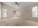 Bedroom with a ceiling fan, access to backyard, and natural light throughout the interior at 10280 N 94Th Dr, Peoria, AZ 85345