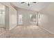 Bright main bedroom with ensuite bathroom, ceiling fan, neutral walls and carpet, and backyard access at 10280 N 94Th Dr, Peoria, AZ 85345