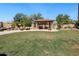 Backyard featuring a lawn, a stone pool, a covered gazebo, and desert landscaping at 10434 N 44Th N St, Phoenix, AZ 85028