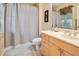 Bathroom featuring a shower with a curtain, a single sink vanity, and neutral tile flooring at 10434 N 44Th N St, Phoenix, AZ 85028