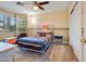 Bedroom with a gray metal bed frame, colorful stripes, and a window with blinds at 10434 N 44Th N St, Phoenix, AZ 85028