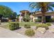 Charming home with mature palm trees, lush green lawn, and meticulous rock landscaping at 10434 N 44Th N St, Phoenix, AZ 85028
