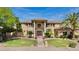 Stunning home featuring meticulously manicured landscaping, mature palms, and a welcoming, covered entryway at 10434 N 44Th N St, Phoenix, AZ 85028