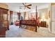 Spacious bedroom featuring a four-poster bed, elegant decor, and a cozy sitting area by the window at 10434 N 44Th N St, Phoenix, AZ 85028