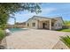 This backyard includes a covered patio, a pool and desert landscaping at 11872 W Duane Ln, Peoria, AZ 85383