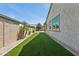 Narrow backyard features artificial grass and desert landscaping at 11872 W Duane Ln, Peoria, AZ 85383