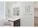 This bathroom is complete with framed mirrors, towel racks and a vanity with storage at 11872 W Duane Ln, Peoria, AZ 85383