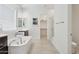 The primary bath features a soaking tub, glass enclosed shower and neutral tile floor at 11872 W Duane Ln, Peoria, AZ 85383