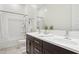The spacious bathroom features double sinks, stylish mirrors, and a shower/tub combo at 11872 W Duane Ln, Peoria, AZ 85383