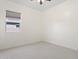 Empty room with large window, ceiling fan and neutral color palette at 11872 W Duane Ln, Peoria, AZ 85383