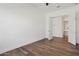 The bright bedroom offers wood-look floors, a ceiling fan and a door to the bath at 11872 W Duane Ln, Peoria, AZ 85383