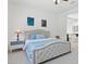 This bedroom features a luxurious upholstered bed frame with a calming, neutral color palette at 11872 W Duane Ln, Peoria, AZ 85383