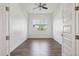 Bright bedroom features a ceiling fan, wood-look floors and large window for natural light at 11872 W Duane Ln, Peoria, AZ 85383