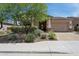 Charming single-story home featuring a well-manicured front yard with lush landscaping and a welcoming two-car garage at 11872 W Duane Ln, Peoria, AZ 85383