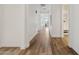 Bright hallway with wood floors, white walls, and doorways leading to other rooms in the house at 11872 W Duane Ln, Peoria, AZ 85383