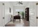 Bright home office features a wooden desk, neutral chair, decorative rug, and built-in shelves, with a window overlooking the backyard at 11872 W Duane Ln, Peoria, AZ 85383