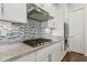 Close-up of the kitchen featuring granite countertops, a gas range, and stainless steel appliances at 11872 W Duane Ln, Peoria, AZ 85383