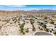 Expansive aerial view of a desert community with homes featuring solar panels and breathtaking mountain views, showcasing sustainable living at 12035 S 186Th Ave, Goodyear, AZ 85338