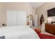 Bright bedroom with walk-in closet and dresser with TV at 12035 S 186Th Ave, Goodyear, AZ 85338