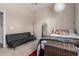 Cozy bedroom featuring a dark futon and a comfortable queen sized bed at 12035 S 186Th Ave, Goodyear, AZ 85338