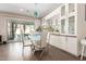 Elegant dining area with stylish light fixture, built-in display cabinets, and access to outdoor living space at 12035 S 186Th Ave, Goodyear, AZ 85338