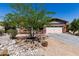 Attractive single-story home with a well-manicured front yard and desert landscaping at 12035 S 186Th Ave, Goodyear, AZ 85338
