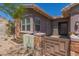 Close up of home with a private gate and stone and stucco design at 12035 S 186Th Ave, Goodyear, AZ 85338