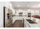 Elegant kitchen with stainless steel appliances, white cabinets, and a large island with seating at 12035 S 186Th Ave, Goodyear, AZ 85338