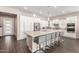 Elegant kitchen with stainless steel appliances, a large island, and sleek white cabinets at 12035 S 186Th Ave, Goodyear, AZ 85338