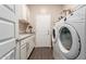 Laundry room with sink, cabinets and front load washer dryer at 12035 S 186Th Ave, Goodyear, AZ 85338