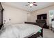 Cozy bedroom with a large bed and dresser, complemented by soft carpet and tray ceiling at 12035 S 186Th Ave, Goodyear, AZ 85338