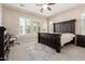 Spacious primary bedroom with neutral walls, plush carpet, and large windows for ample natural light at 12035 S 186Th Ave, Goodyear, AZ 85338