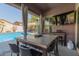 Covered patio with seating and a view of the pool at 12035 S 186Th Ave, Goodyear, AZ 85338