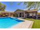 Beautiful pool with a Baja step, offering easy access and a relaxing space to enjoy the outdoors with a view of the home's patio at 12035 S 186Th Ave, Goodyear, AZ 85338
