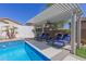 Relaxing poolside pergola with comfortable lounge chairs, offering a perfect spot to unwind and enjoy the sunny backyard at 12035 S 186Th Ave, Goodyear, AZ 85338