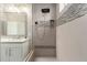 Modern tiled shower featuring a rainfall showerhead and built in niche for toiletries at 12035 S 186Th Ave, Goodyear, AZ 85338