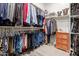 Organized walk-in closet with ample hanging space and shelving for clothes and accessories at 12035 S 186Th Ave, Goodyear, AZ 85338
