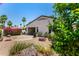 Landscaped backyard features native plants, a patio, and an outdoor dining space with a built-in grill at 14124 W Bent Tree S Cir, Litchfield Park, AZ 85340