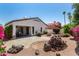 Backyard featuring lush landscaping, a built-in barbecue, and a spacious patio area with outdoor seating at 14124 W Bent Tree S Cir, Litchfield Park, AZ 85340
